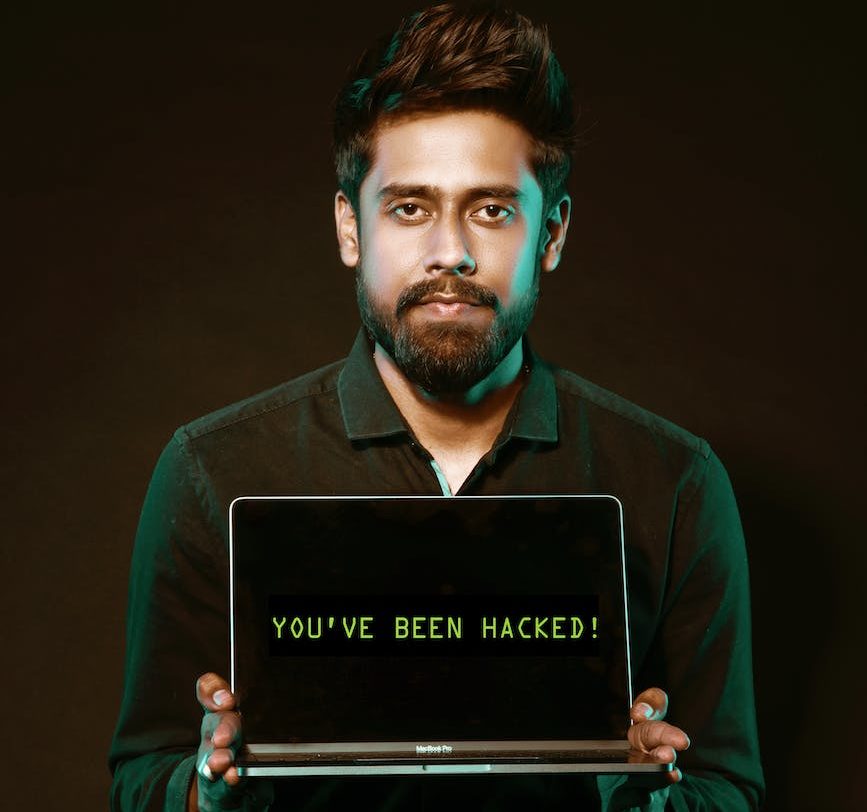 man holding laptop computer with both hands